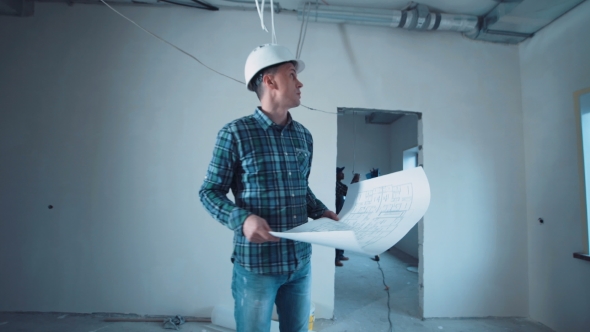 Man on a Site with Blueprint