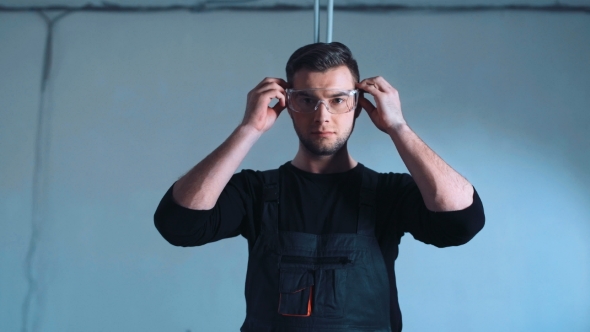 Man Putting Protection and Taking Saw alt