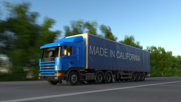 Speeding Freight Semi Truck with MADE IN CALIFORNIA Caption on the Trailer alt