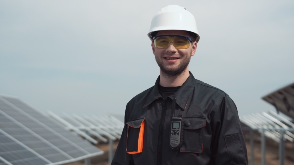 Worker in Hardhat Looking Camera alt
