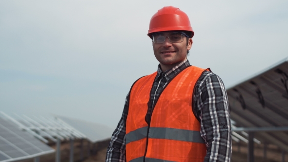 Worker in Hardhat Looking Camera alt