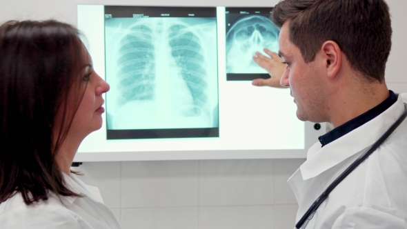 Male Doctor Explaines Something on X-ray To His Female Colleague