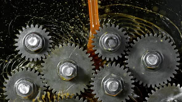 Super Slow Motion Shot of Gear Mechanism and Oil on Dark Background at 1000 Fps