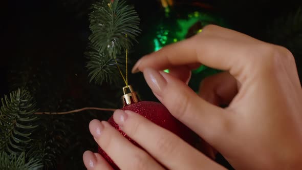 Woman's Hands Decorate the Christmas Tree with Toys in the Hotel Woman is Preparing for the