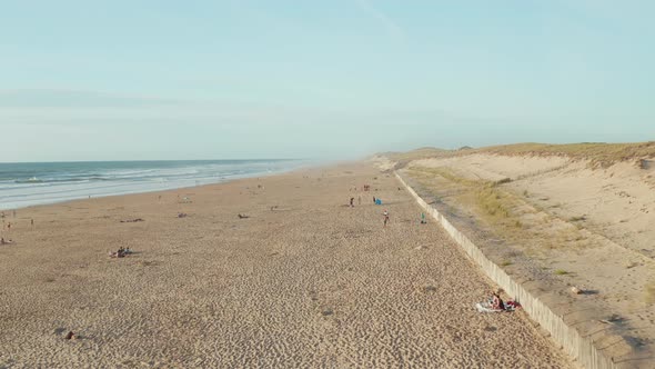 Beautiful Beach in South of France Coast with People Enjoying Time in the Sand on Sunny Day, Aerial