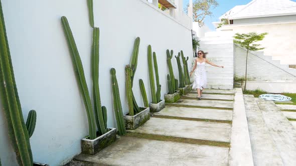 Young Happy Woman Run and Whirl Near Cactuses