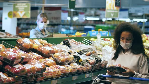 Women in Face Masks are Shopping in the Fruit Section