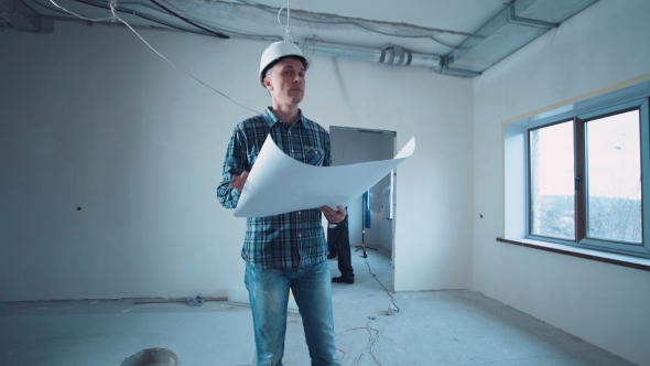 Man on a Site with Blueprint