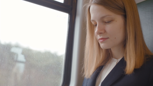 Nice Business Lady Is Sitting By the Window in Train 