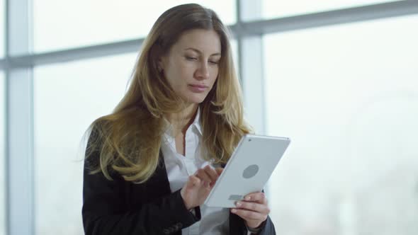 Businesswoman Typing on Tablet