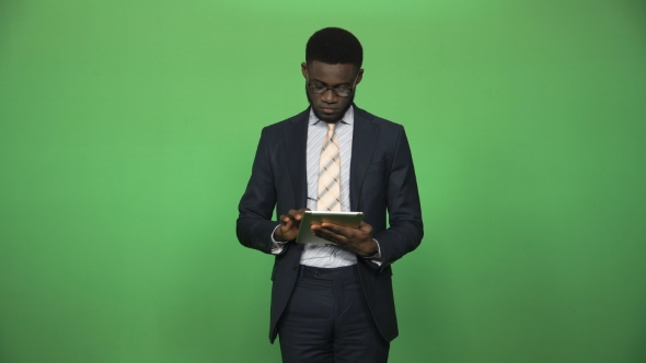 Confident African Male Using Tablet
