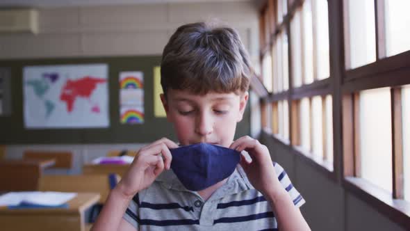 Boy wearing face mask in the class at school