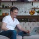 Portrait of Caucasian Handsome Mature Man Sitting on Sofa in Living Room Apartment Speaking on Video - VideoHive Item for Sale