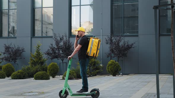 A Man is Talking on the Phone While Riding an Electric Scooter