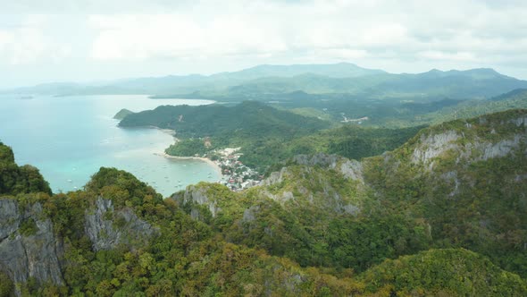 WS AERIAL Coastal mountains and distant city, El Nido, Palawan, Philippines