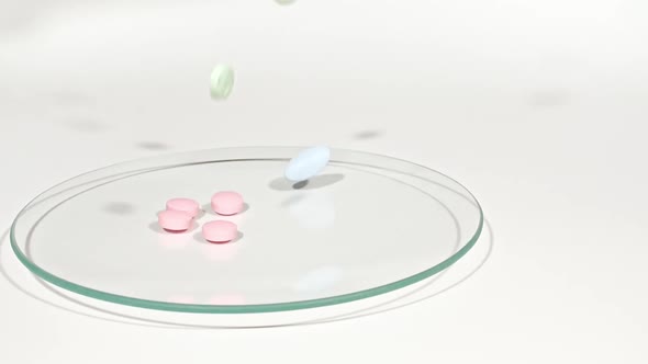 Closeup of Different Medical Pills Falling on Petri Dish on White Background