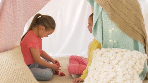 Happy Girls in Kids Tent Playing Tea Party at Home