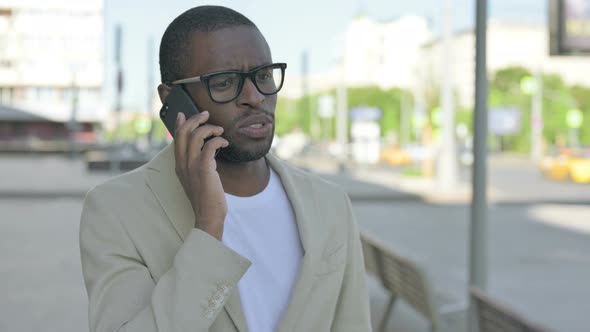 Portrait of African Man Talking on Phone Outdoor