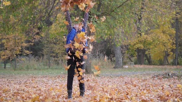 Autumn. Children Play with Fallen Leaves of Trees.