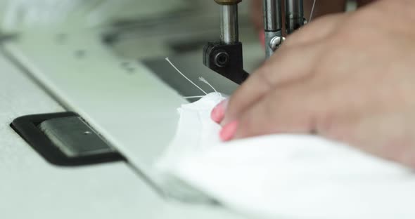 Sewing a facemask for protection during the Corona pandemic - close up pan