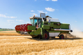Combine harvester working on a wheat field. - PhotoDune Item for Sale