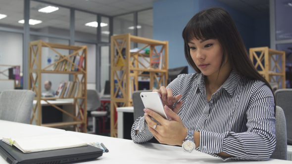 Asian Girl with Smartphone 7 in Office.