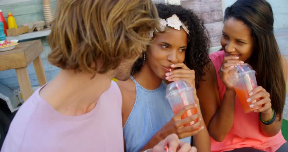 Happy friends having juice