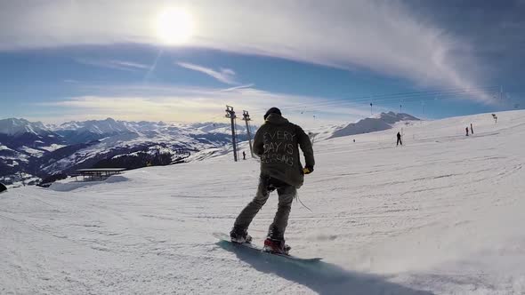 A young man snow boarding.