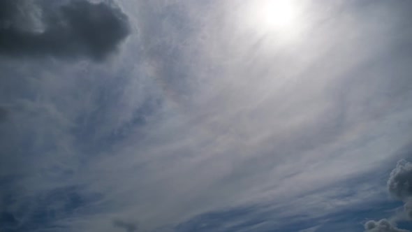 Clouds Move Smoothly in the Blue Sky on Background of Sun. Timelapse