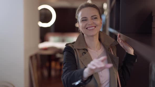 Excited Caucasian Wealthy Woman Touching Cabinet in Furniture Showroom Gesturing Excitement