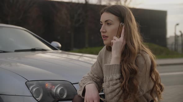 Young Upset Woman Making Phone Call After Traffic Accident