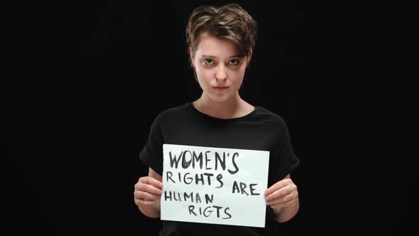 Portrait of Confident Beautiful Brunette Woman Posing with Placard Womens Rights are Human Rights