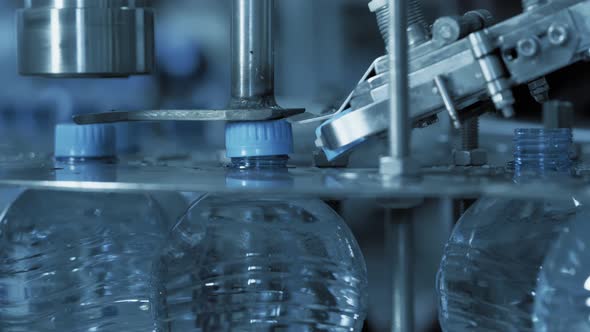 Plastic Bottles Filled with Clean Water on Automatic Belt Line at Plant Enterprise.