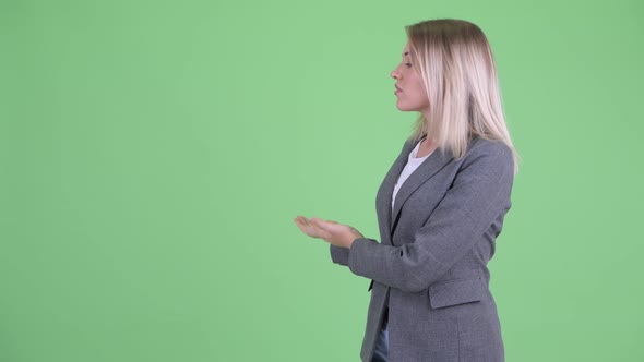 Stressed Young Blonde Businesswoman Showing To the Back