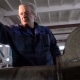 Senior Mechanic in Overalls in Heavy Machine Workshop. Hard Surfacing By Submerge Arc Welding - VideoHive Item for Sale