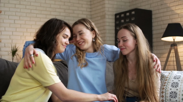 Two Young Woman Bear Up and Calm Down Their Best Friend Who Is Upset and Depressed