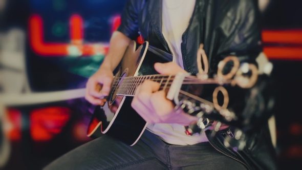 An Anonymous Guy Playing the Guitar