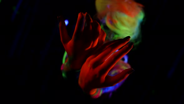 Bright Makeup and Body Art in UV Light in Dark Room Woman is Moving Slowly Neon Paints