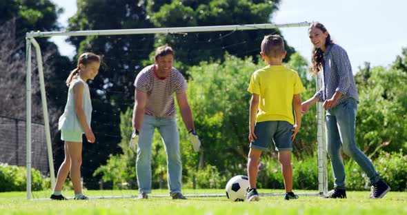 Happy family playing football