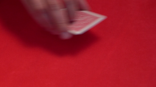Dealer Hand Checking Five Cards in Poker Game
