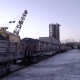 PAN of Sets of Gandola Cars with Copper Ore in Winter. Excavator Boom in the Background. - VideoHive Item for Sale