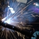 Welder Builds Up the Metal on the Workpiece. Sparks From Welding. Welding Mask - VideoHive Item for Sale