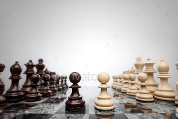 the board. Creative success business concept meaningful photo of two pawns opposition in the middle of the checkerboard.