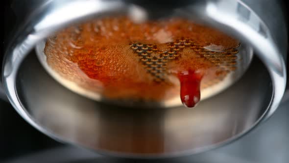 Super Slow Motion Macro Shot of Dripping Fresh Espresso Coffee From Lever Machine at 1000 Fps