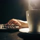 Typing on a laptop keyboard, drinking coffee - VideoHive Item for Sale