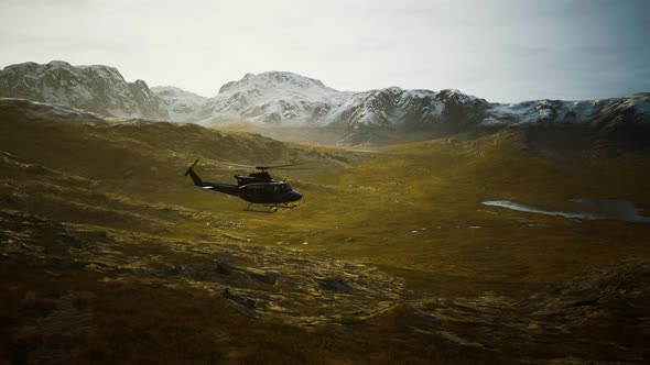 Slow Motion Vietnam War Era Helicopter in Mountains alt