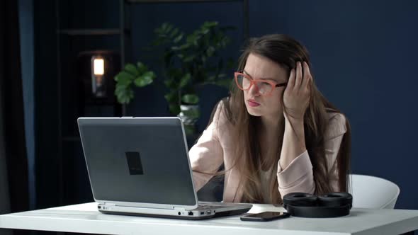 Business Woman Works Late at Night in the Office