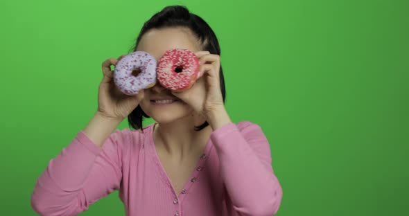 Happy Beautiful Young Girl Posing and Having Fun with Donuts. Chroma Key