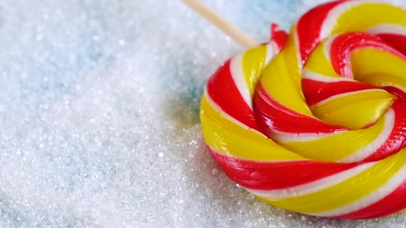 Bright Candy Is on the Background of Sugar. Eating Sugar and Its Effects on Health.