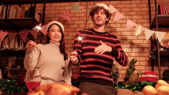 Two friends dancing with fireworks, celebrate Christmas party.